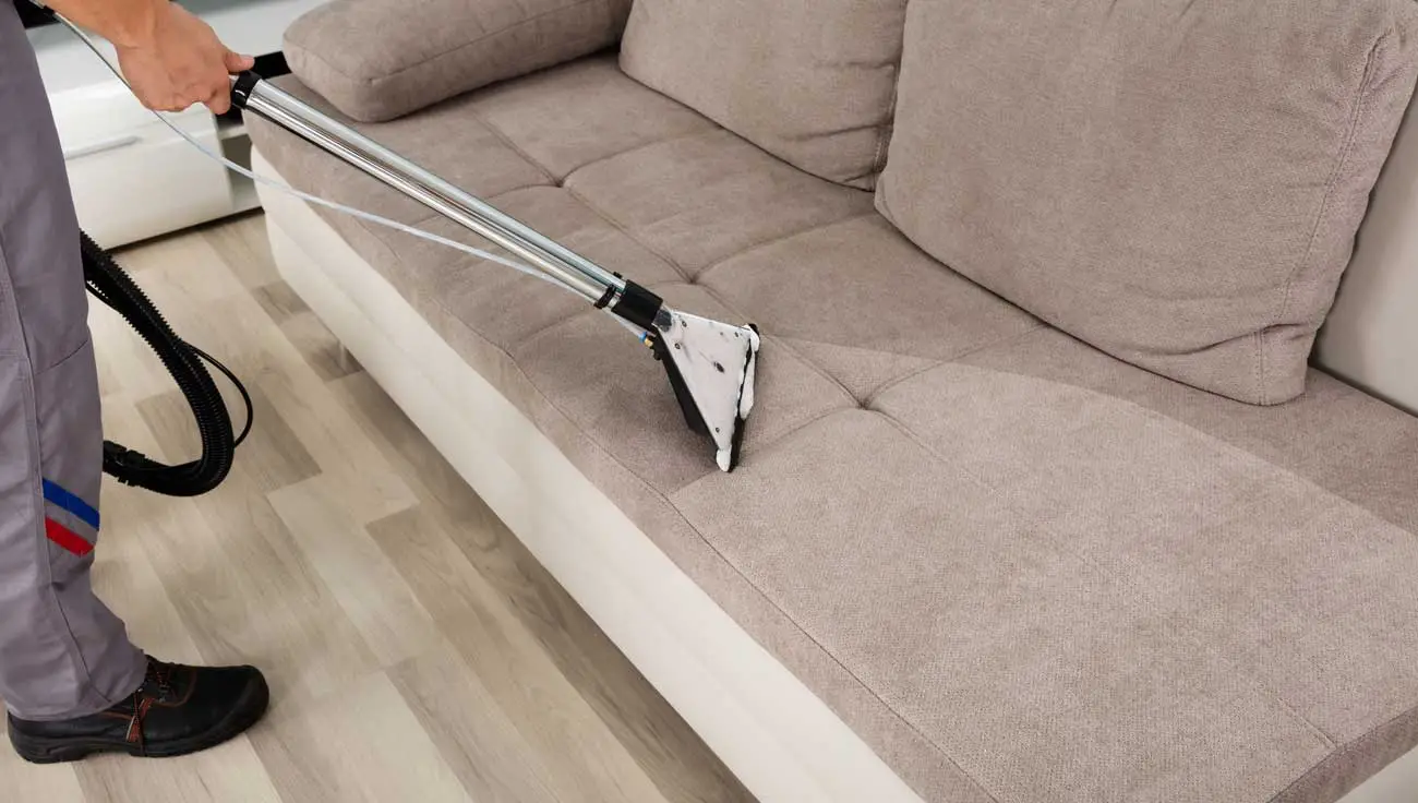 Residential and commercial interior cleaning in Phoenix by First Class Green Cleaning showing person cleaning furniture