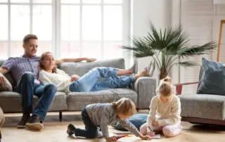 Residential and commercial interior cleaning in Phoenix by First Class Green Cleaning showing family enjoying a clean living room