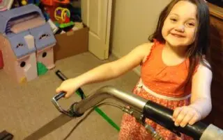 Residential and commercial interior cleaning in Phoenix by First Class Green Cleaning showing little girl carpet cleaning