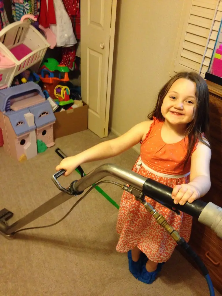 Residential and commercial interior cleaning in Phoenix by First Class Green Cleaning showing little girl carpet cleaning