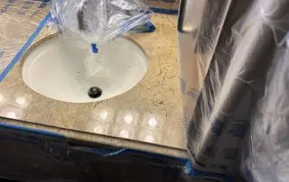 Bathroom vanity sink area after countertop polishing