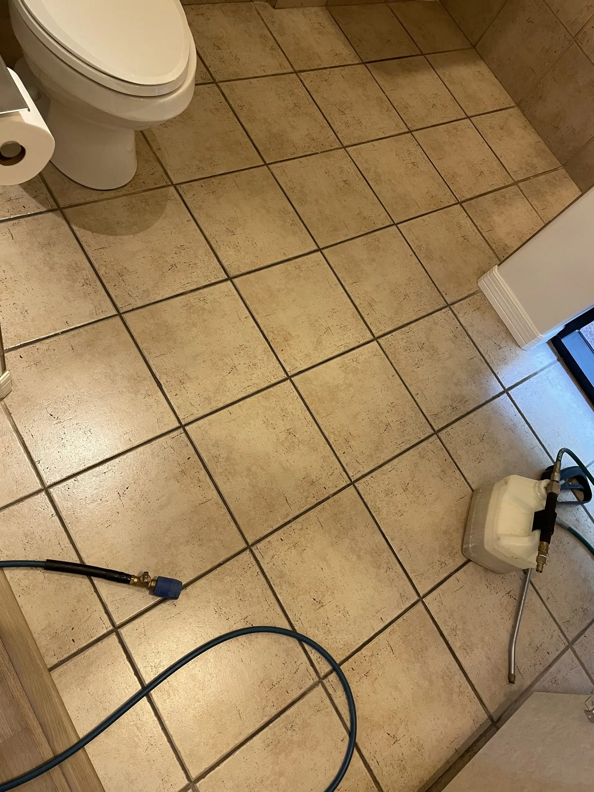 Beige ceramic restroom tile before cleaning