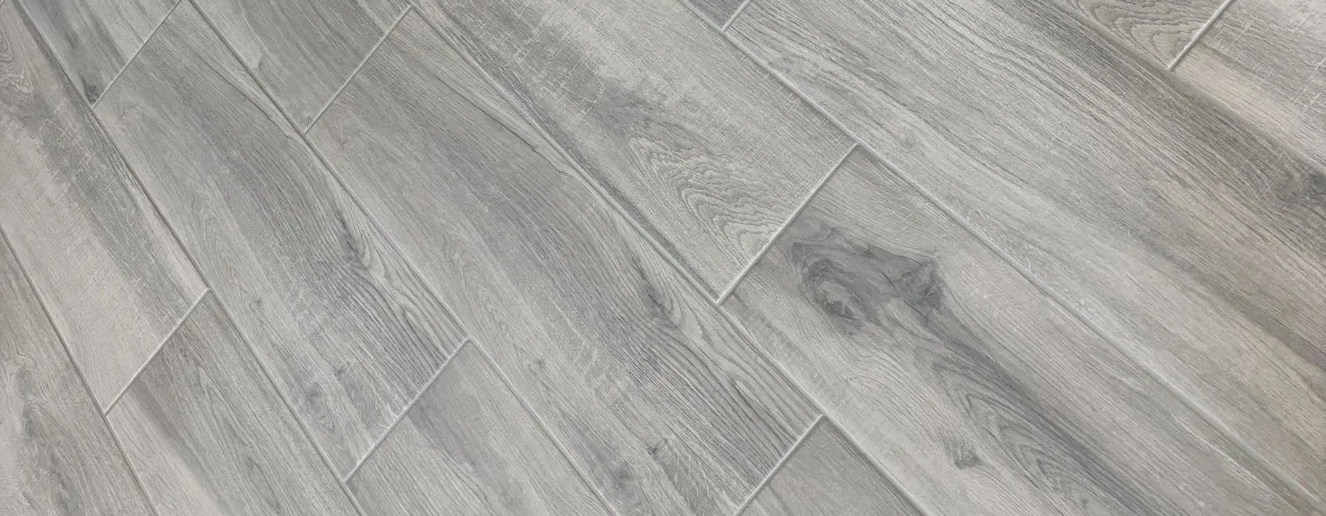Grey wood-look plank tile floor after professional cleaning